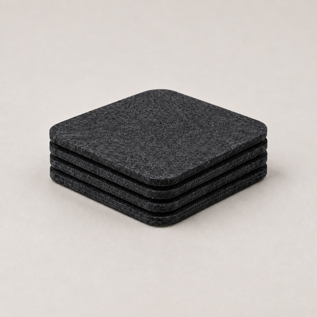 The Felt Coasters, four stacked, on a light background